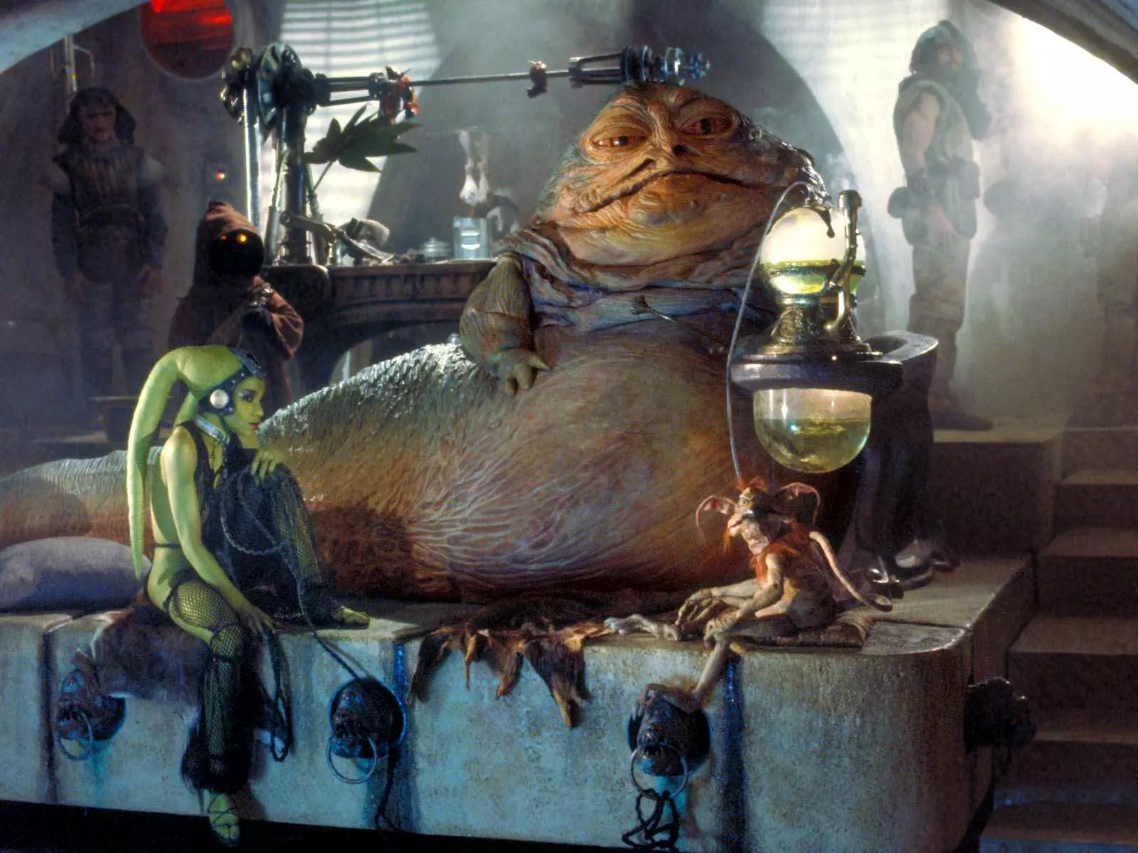 Luke Skywalker meets with Jabba the Hutt, who flaunts his power by exploiting Princess Leia as his slave.