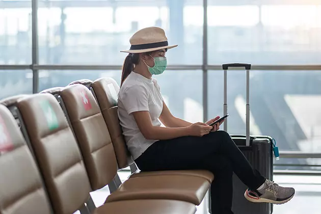 Travellers wearing masks in the airport