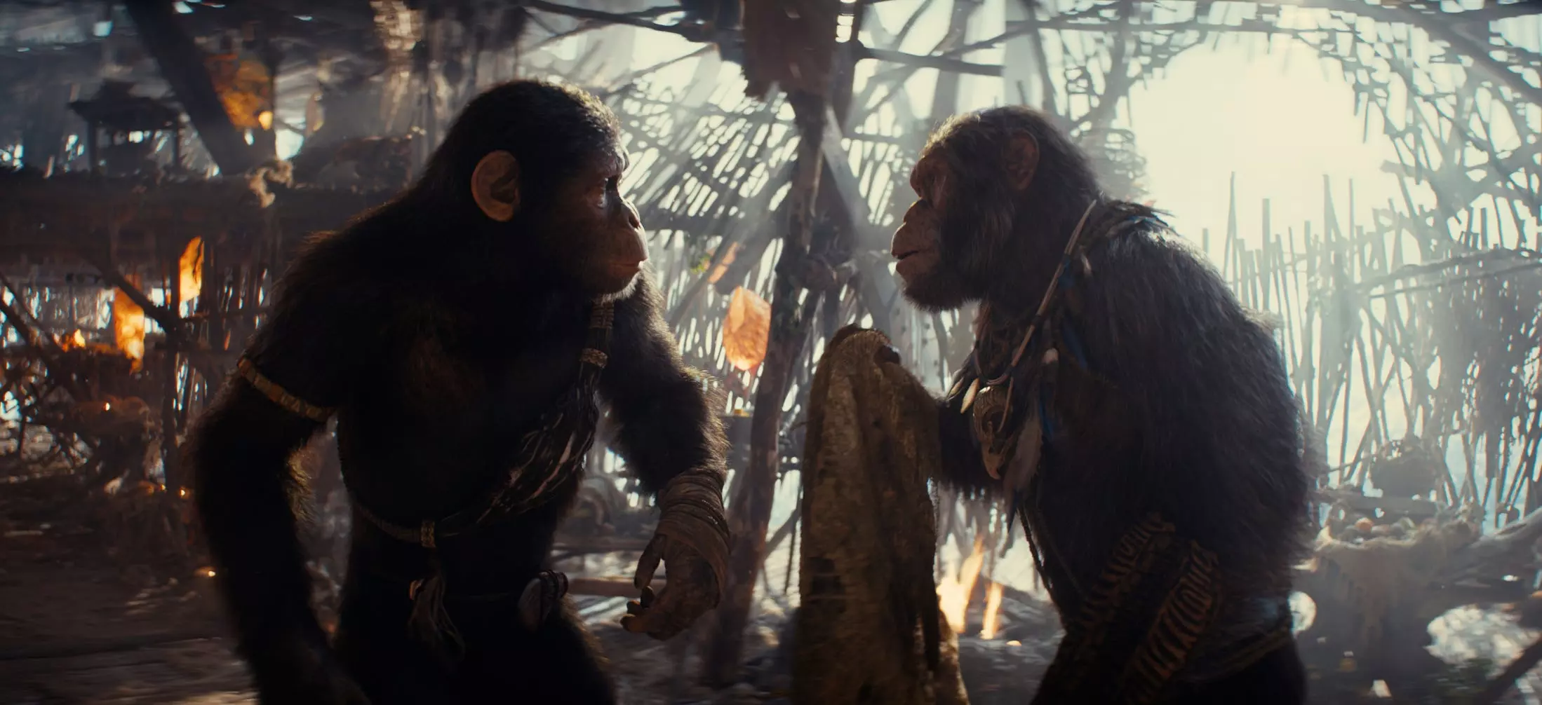 Noa (played by Owen Teague, left) is advised by his father, tribal elder Koro (Neil Sandilands), in the sci-fi action movie "Kingdom of the Planet of the Apes."