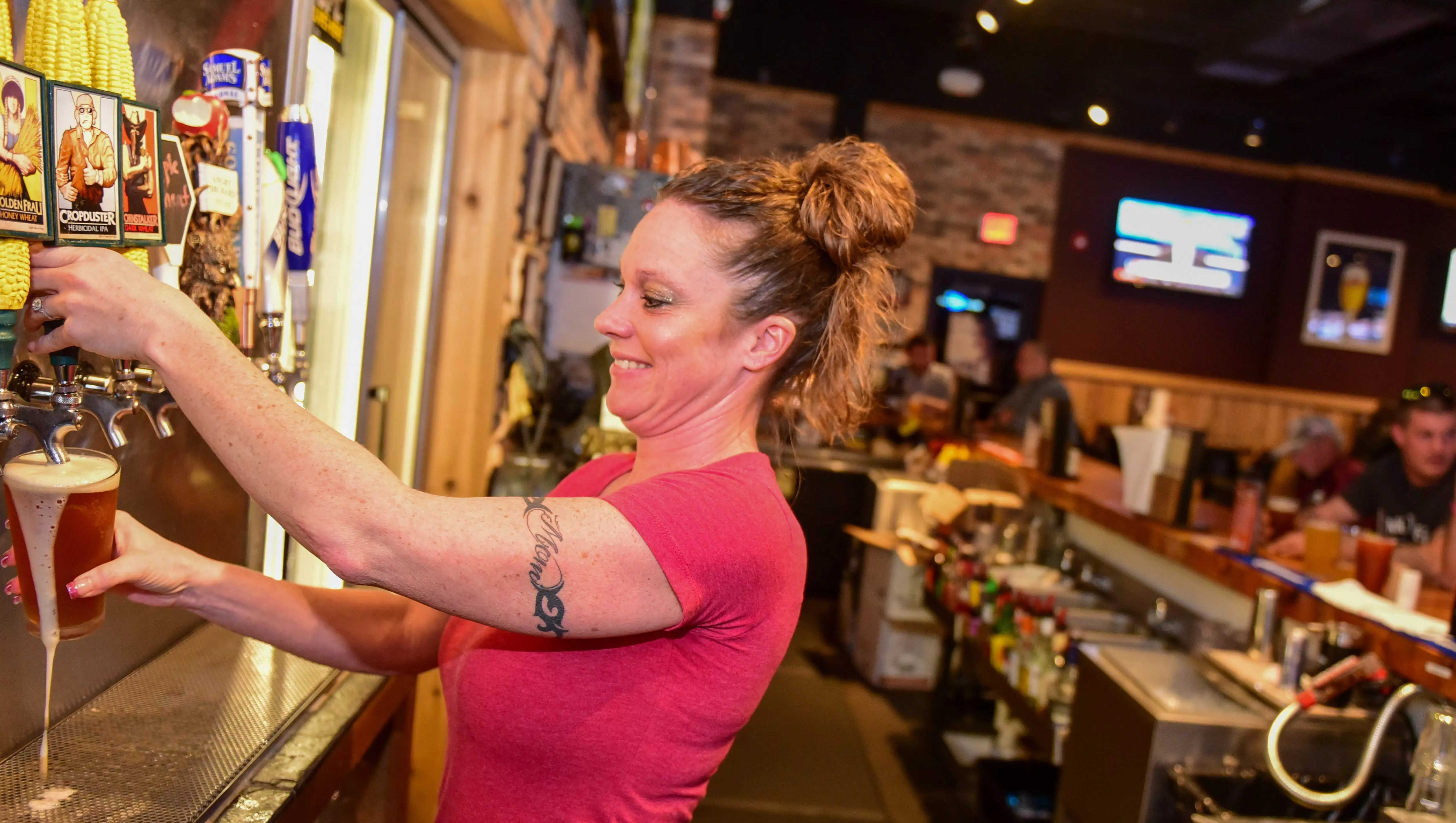 Bartender Kim Staker draws a craft ale made by Thunderhead Brewing at Chicken Coop Sports Bar & Grill in Urbandale.