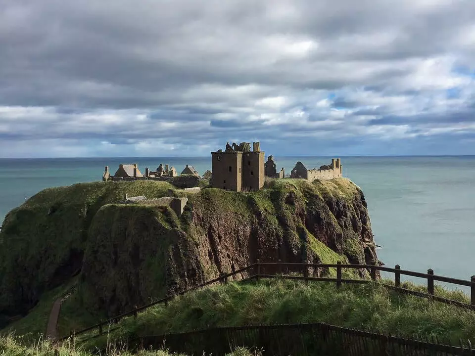 dunnottar castle in scotland green hills ruin ocean