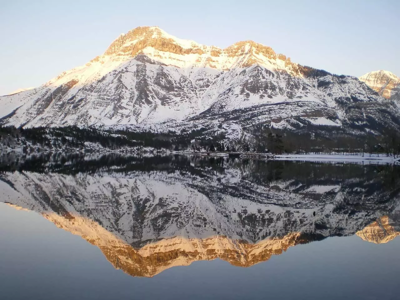 A lake reflecting the mountains in Waterton Lakes National Park