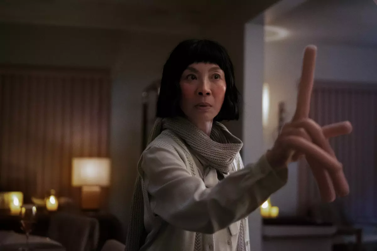 Evelyn (Michelle Yeoh) lives out several different realities, including one where she has hot dog fingers, in the sci-fi comedy "Everything Everywhere All at Once."