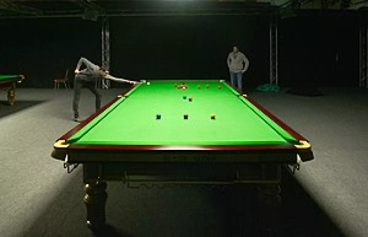 A full-size snooker table set up for the start of a game