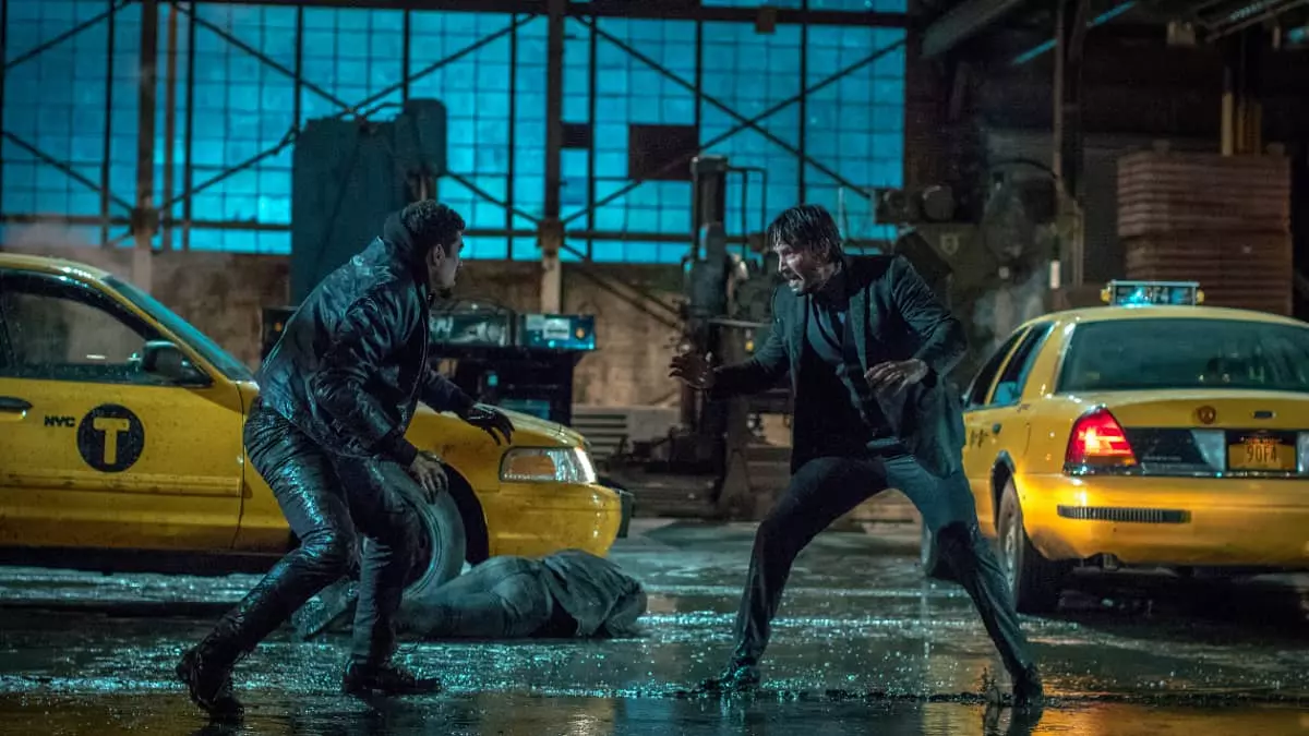Keanu Reeves in a fight scene on a street in the rain in John Wick Chapter 2