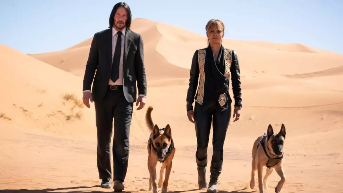 John Wick (Keanu Reeves) and Sofia Al-Azwar (Halle Berry) walking in a desert