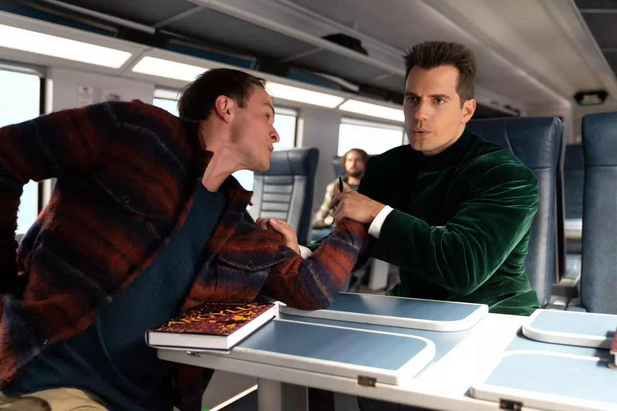 Agent Argylle (Henry Cavill) gets ready to wreck a dude on a train in the action spy comedy "Argylle."