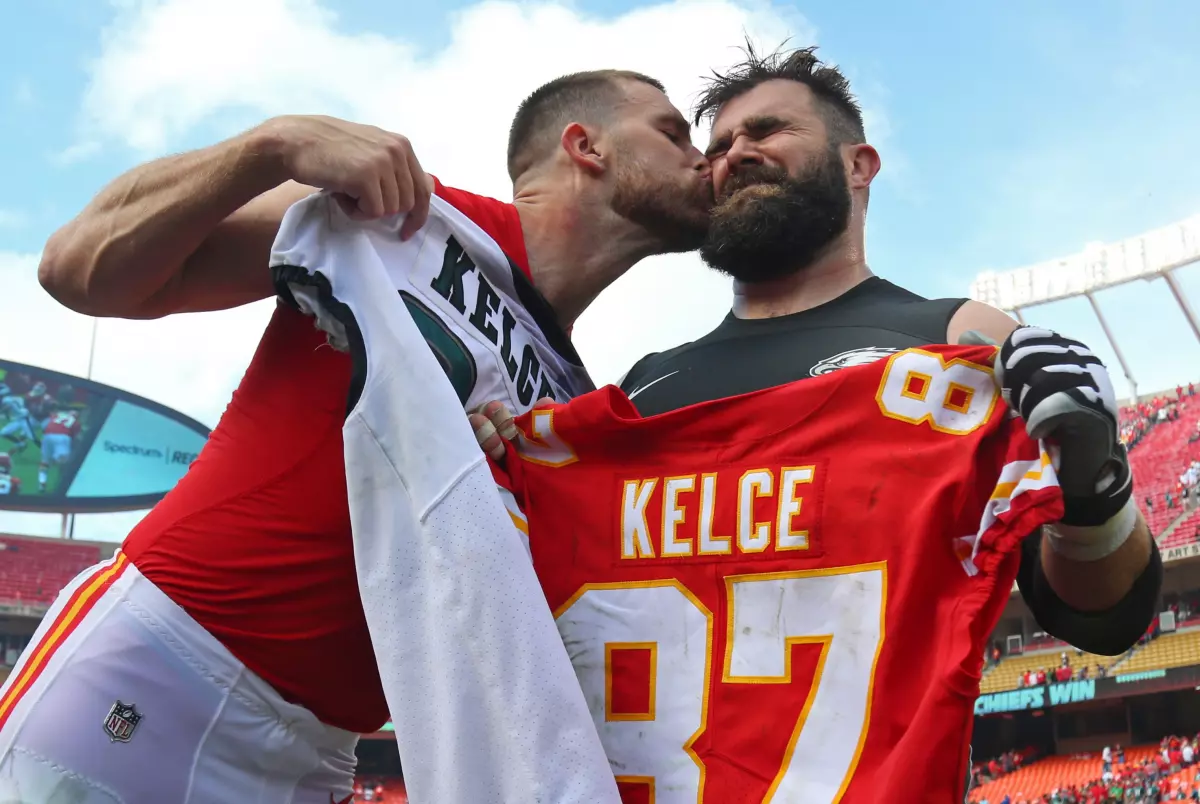 Chiefs tight end Travis Kelce kisses Eagles center Jason Kelce after a game at Arrowhead Stadium in 2017.