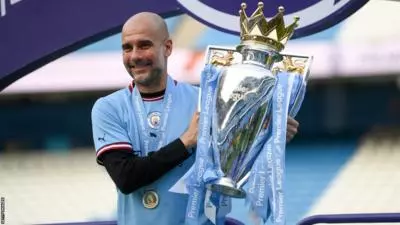 Manchester City boss Pep Guardiola lifts the Premier League title after winning the 2022-23 league